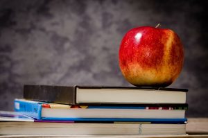 An apple with books - representative of learning